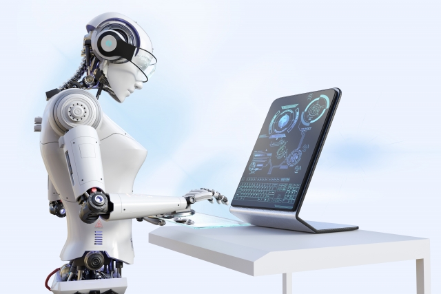 パソコンと向き合うロボット